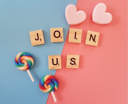 Join us spelled with wooden blocks on pastel backround